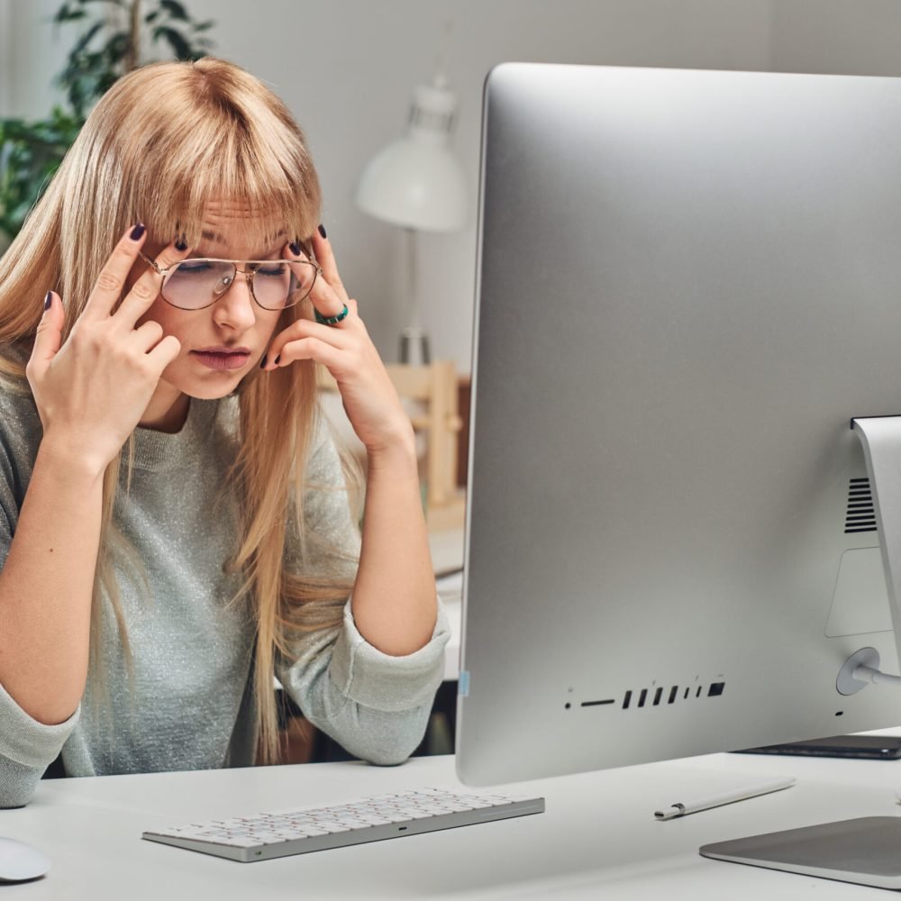 a woman staring at a computer in frustration that has questions